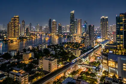 Bangkok skyline at night with lit towers and the Chao Phraya River