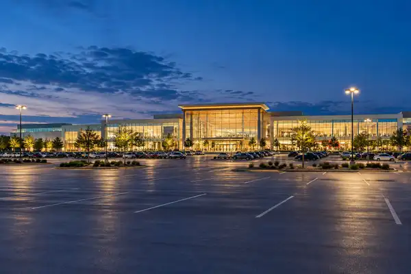 Central Festival mall in Chiang Mai: large glass facade glowing at blue hour above a car park