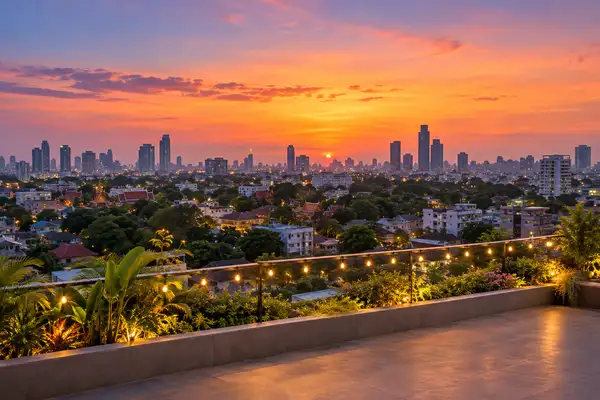 Indy Massage Chiang Mai: Nimman rooftop bars skyline at dusk with string lights and low buildings
