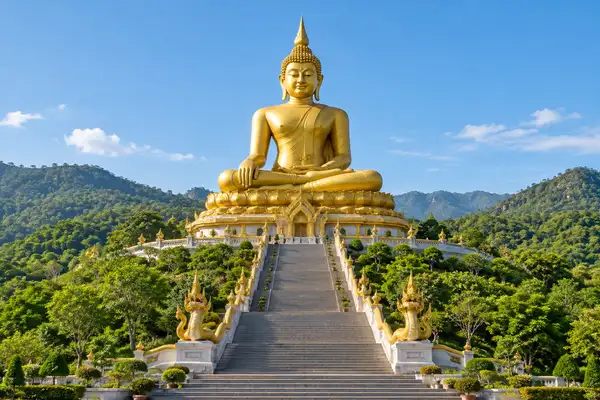 Indy Massage Pattaya: Large golden seated Buddha on a green hill with a long staircase in Pattaya
