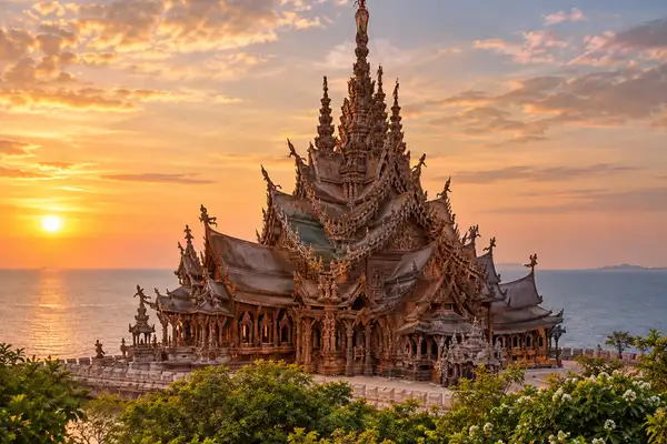 Indy Massage Pattaya: Carved wooden Sanctuary of Truth building with tall spires beside the sea in Pattaya