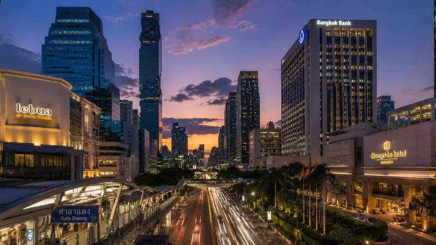 In room massage near ESSE Sukhumvit 36, with towers and the BTS Skytrain on the street at dusk | Indy Massage Bangkok