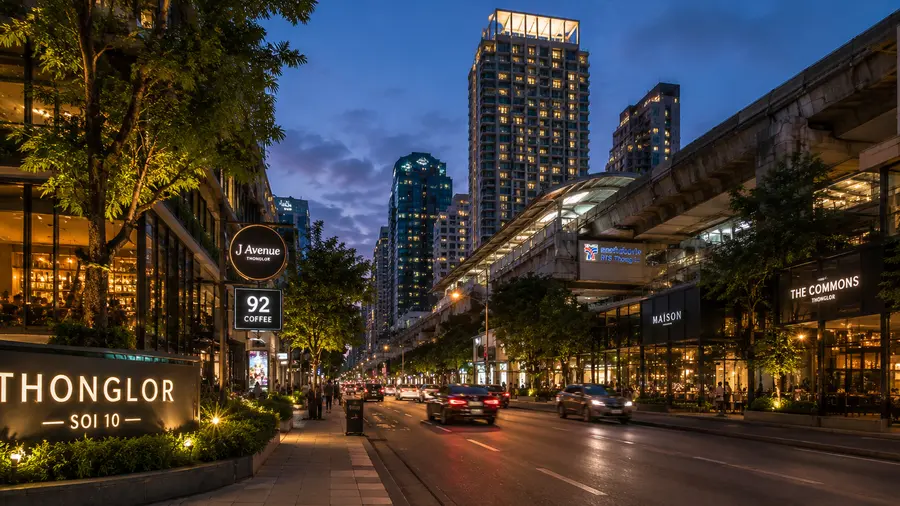 In room massage near the Residence Thonglor, with a Soi 10 sign and an evening road | Indy Massage Bangkok